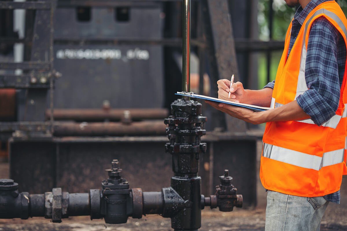 workers-standing-checking-beside-working-oil-pumps (1) (1)